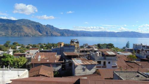 a city with a view of the water and buildings at Una Noche Con Mical in San Pedro La Laguna