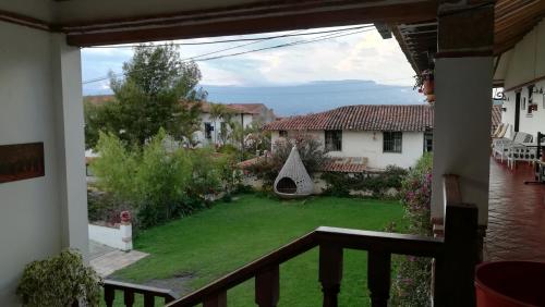 a view from the balcony of a house with a yard at Hotel Santa Viviana Villa de Leyva in Villa de Leyva