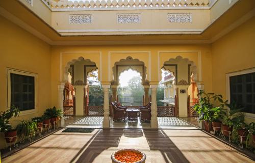 a lobby of a house with a bowl of food on the floor at Alsisar Haveli - Heritage Hotel in Jaipur
