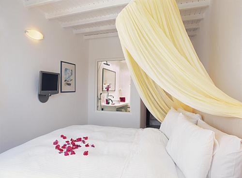 a bedroom with a bed with flowers on it at Zephyros in Paraga