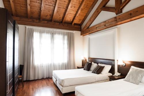 En eller flere senge i et værelse på Country Hotel Castelbarco