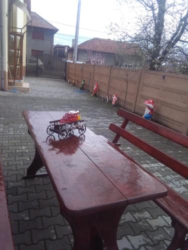 a wooden picnic table with a toy on top of it at Casa Ovi și Simo in Haţeg