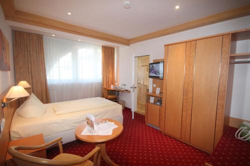 Ένα ή περισσότερα κρεβάτια σε δωμάτιο στο Genuss- und Wellnesshotel Bercher