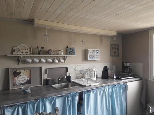a kitchen with a sink and a counter top at Clair Matin in Villeneuve-dʼAllier