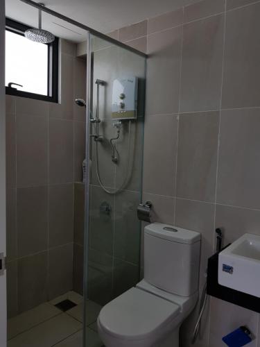 a bathroom with a shower and a toilet and a sink at Eclipse Residence Pangea in Cyberjaya