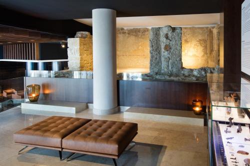 a large room with a large stone fireplace at Áurea Museum by Eurostars Hotel Company in Lisbon
