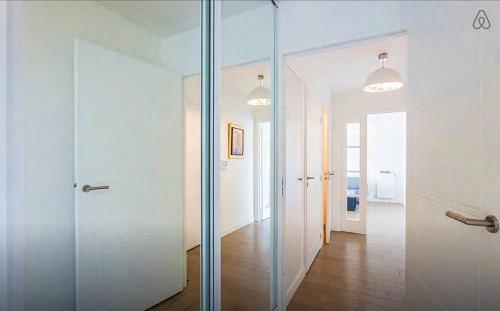 Cette chambre dispose de portes vitrées et d'un couloir. dans l'établissement Vue sur Seine Musicale, à Boulogne-Billancourt