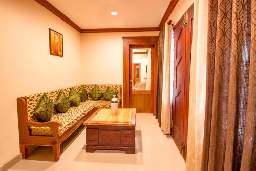 a living room with a couch and a table at Crown Valley Thekkady in Thekkady