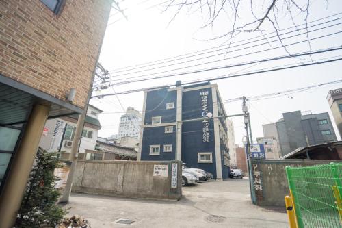 a building with writing on it in a city at Beewon Guesthouse in Seoul