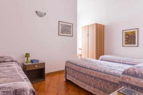 プトゥツ・イドゥにあるAppartamento Con Terrazza Sul Mareのベッド2台とキャビネット付きのホテルルームです。