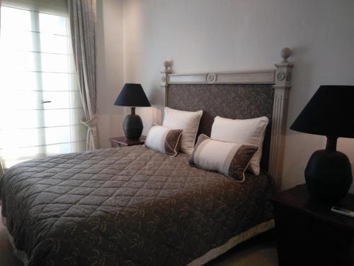 a bedroom with a large bed with two pillows at St. Agatha's Bastion in Mdina