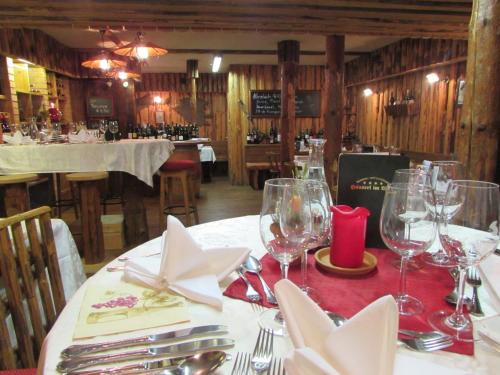 a dining room with a table with wine glasses at Landhotel Häuserl im Wald in Gröbming