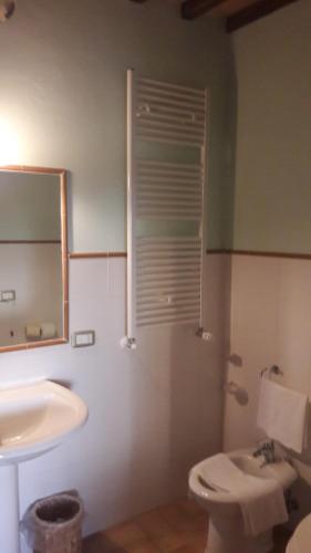 a bathroom with a sink and a toilet and a mirror at Affittacamere da Laura Silvi in Orvieto