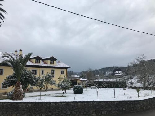 a house with snow on the ground in front of it at Casa de Aldea El Frade in Ribadesella