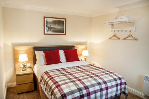 A bed or beds in a room at The Fir Tree Country Hotel