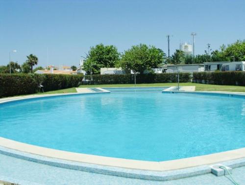 a large swimming pool with blue water at Parque Campismo Porto Côvo in Porto Covo