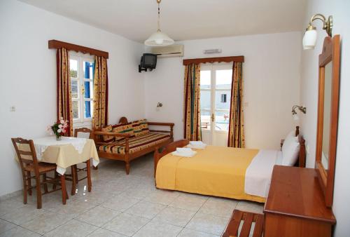 a bedroom with a bed and a table and a chair at Panorama in Amorgos