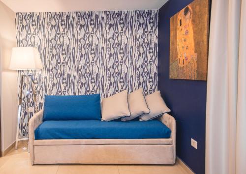 a room with a blue couch with a curtain at Airone Hotel in Naples