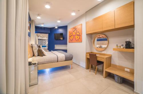 a bedroom with a bed and a desk and a desk at Airone Hotel in Naples