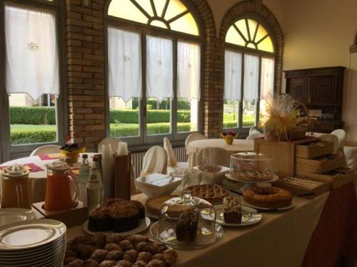 a table with many plates of food on it at Hotel Villa San Donino in Città di Castello