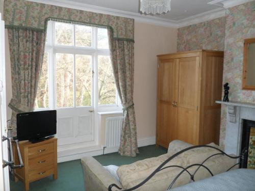a living room with a couch and a window at Big Sky Guest House- ROOM ONLY in Whitby