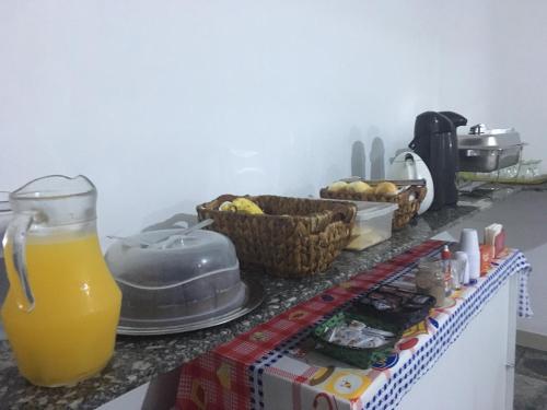 a counter with a glass of orange juice on it at Hotel City Sacomã in São Paulo