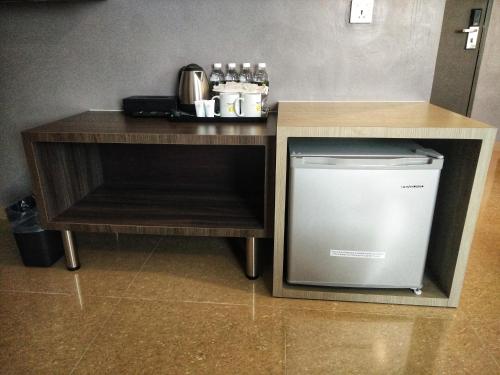 a small kitchen with a counter and a dishwasher at Kampar Boutique Hotel in Kampar
