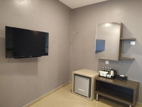 a room with a flat screen tv on the wall at Kampar Boutique Hotel in Kampar