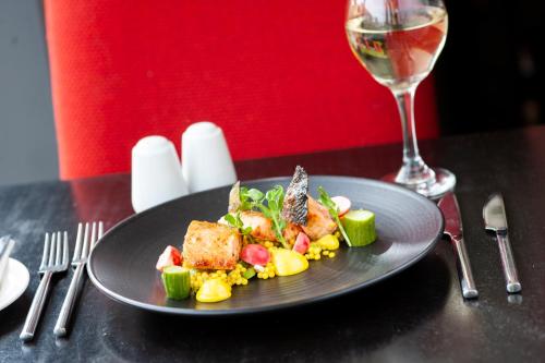 a plate of food on a table with a glass of wine at The Glasshouse in Sligo