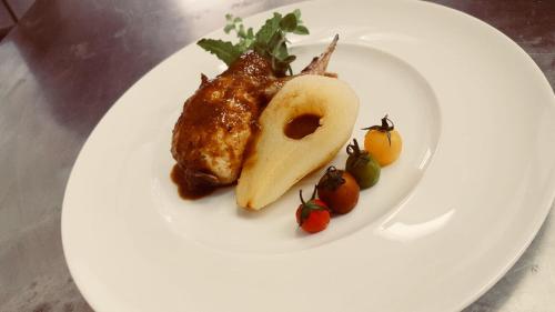 a plate of food with meat and fruit on it at Hotel Villa San Donino in Città di Castello