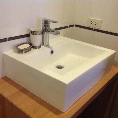 a white sink with a mixer on top of it at BanSanKram by Patsara in Ban Huai Sai Tai