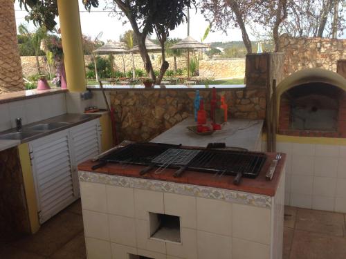 a kitchen with a counter with a stove top oven at Casa Paula Villas - Private Heatable Pool for Each House in Lagos