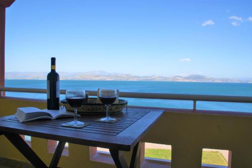 a table with a bottle of wine and two glasses at Kiveri Gems Houses in Kivérion