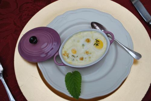 a plate with a bowl of soup with a bee on it at La Maison d'Hocquincourt in Bléneau