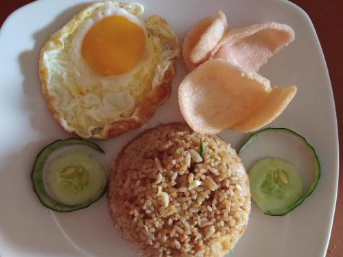 a plate of food with an egg and vegetables at Volcano Living in Kintamani