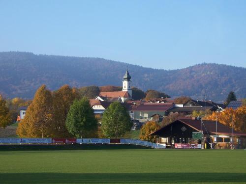 a town with a clock tower and a green field at Lallinger Hof in Lalling