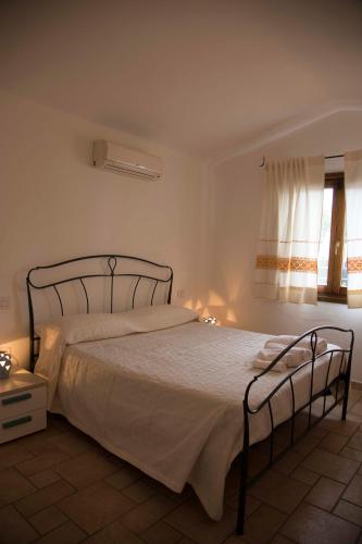 a bedroom with a bed in a room with a window at Bados Mare in Olbia