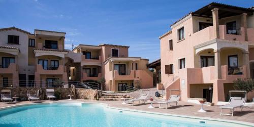 a villa with a swimming pool in front of a building at Bados Mare in Olbia