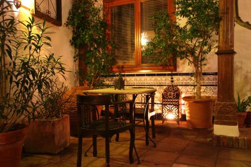 a table and chairs in a room with plants at Boutique Hotel La Posada del Angel Ojén in Ojén