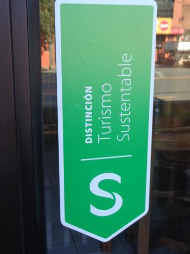 a green sign in the window of a store at Cabanas L'ESCALE in Coñaripe