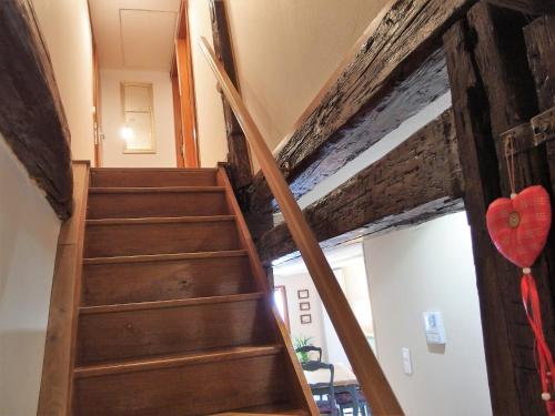 a wooden staircase in a house with a heart balloon at La maison Céline in Bergheim