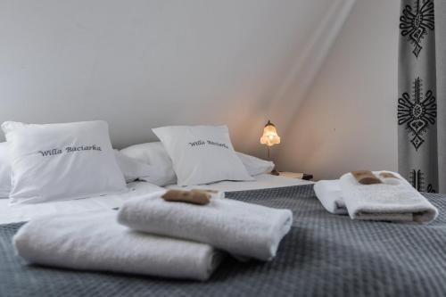 two towels on a bed in a room at Willa Baciarka-basen, sauny i jacuzzi in Kościelisko