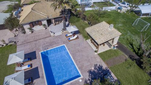 an overhead view of a swimming pool next to a house at Iguana Villa in Kalamaki