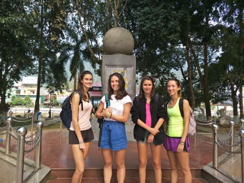 a group of girls standing in front of a statue at Ngan Ha Homestay in Ha Giang