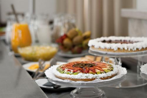 a table with two cakes on top at Hotel Nuevo Ostende by bund in Mar del Plata