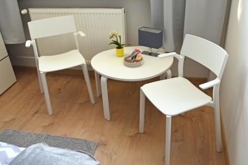 a table with two chairs and a table cloth at Hostel Bratislava in Bratislava