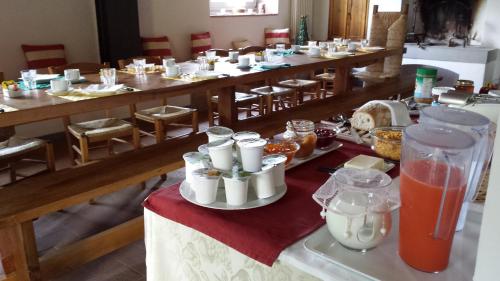 a room with many tables with food and drinks at Il Pezzatino in Rufina
