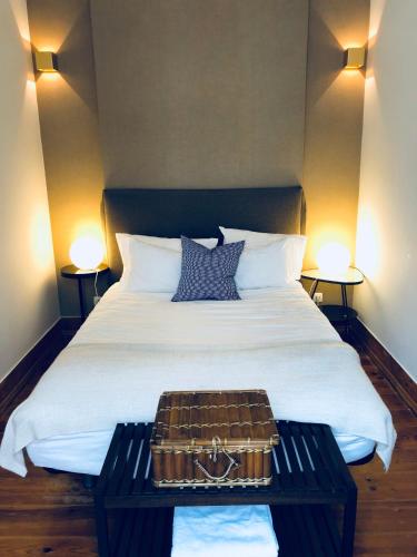 a bedroom with a large bed with a briefcase on it at Bairro Alto in Lisbon