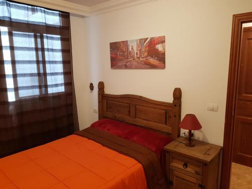 a bedroom with a bed and a table with a lamp at Apartamento Hill Valley in Los Llanos de Aridane