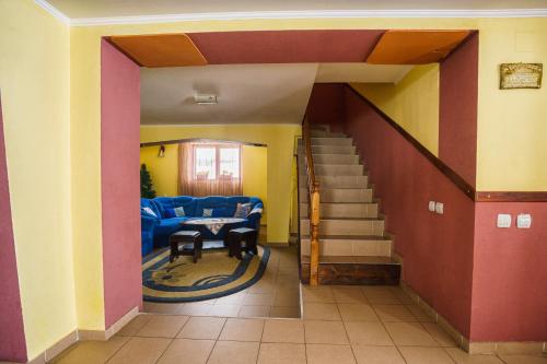 a hallway of a house with a living room and stairs at Piatra Rancii in Ranca